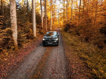 A car on a wooded path, surrounded by dense autumn landscape, electric car, VW ID5, Gechingen,