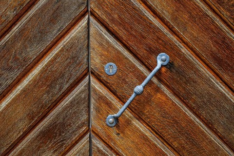 Detail of a historic iron-framed wooden door in the outer wall of the Old Palace in Stuttgart,