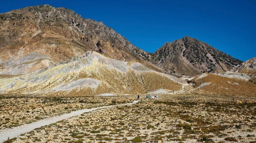Mountain landscape with a path surrounded by rocky hills and clear sky, Volcanism, Volcanic Island,