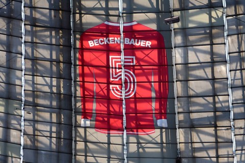 Larger-than-life jersey of Franz Beckenbauer with shirt number 5 hanging in the grandstand roof of