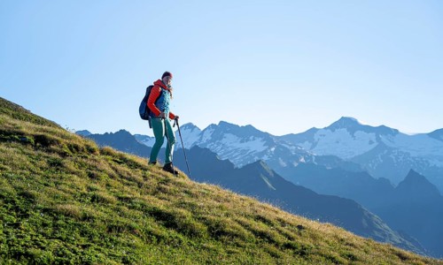 Hiker enjoying the mountain panorama in the morning, Venediger group, behind Dreiherrenkopf,