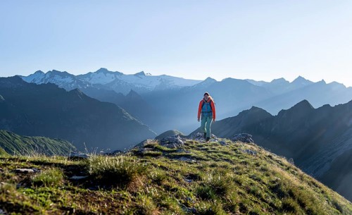 Hiker enjoying the mountain panorama in the morning, Venediger group, behind Dreiherrenkopf,