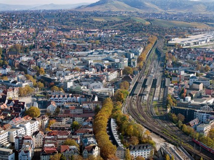Stuttgart Bad Cannstatt with railway station, aerial view. Above it the Mercedes-Benz engine plant