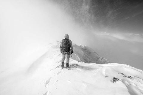 Ski tourer in snowy mountain landscape, at the summit of the Wildhorn, black and white photo,