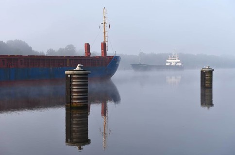 Cargo ship sailing in fog in the Kiel Canal, Kiel Canal, Schleswig-Holstein, Germany, Europe