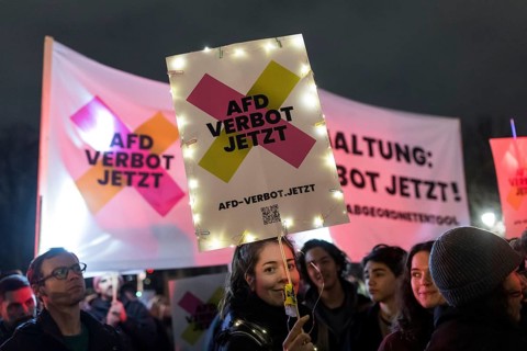 Participants with an AfD ban sign at the demonstration under the motto Sea of Lights against the