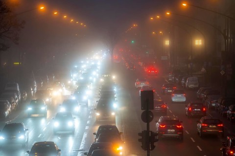 Dense fog, with visibility sometimes less than 100 metres, city centre traffic at rush hour on