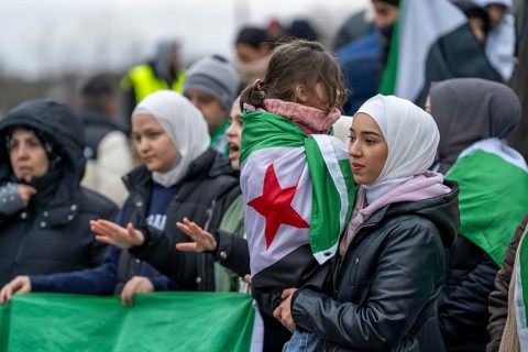 Syrian woman celebrate the end of the Assad regime after the change of power in Syria at a rally on