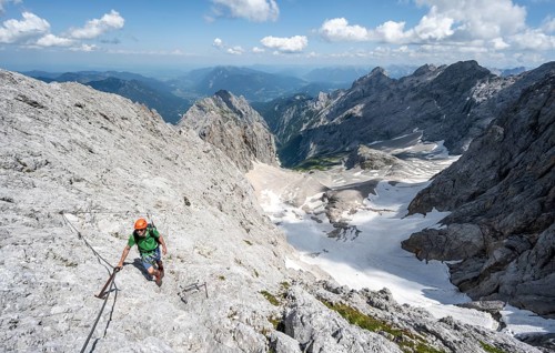 Mountaineer with helmet in a secured via ferrata, Zugspitze via ferrata, ascent to the Zugspitze,