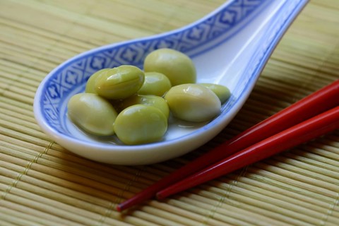 Edamame, unripe soya beans in an Asian ceramic spoon, Glycine max