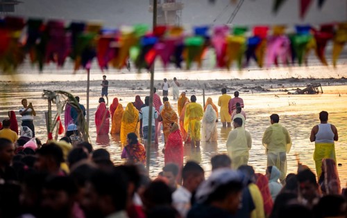 Hindu devotees perform rituals as they offer prayers to the Sun god in the bank of Brahmaputra