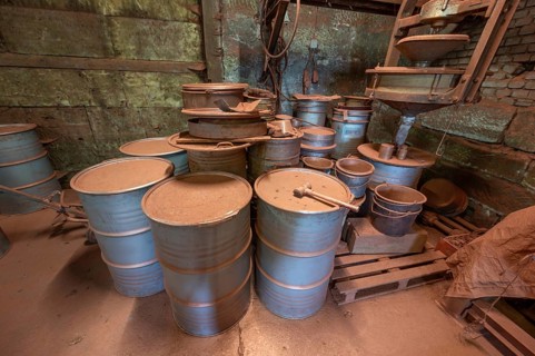 Metal drums for metal powder in the bronze powder filling room of a metal powder mill, founded in