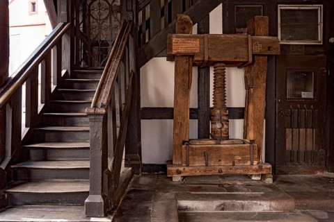 Market hall, old town hall, stairs to the upper floor, wooden cloth press with threaded screw by