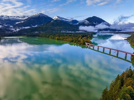 Snow-covered mountains reflected in lake, sunny, bridge, autumn, Sylvensteinsee, Karwendel