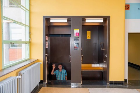 Man waving in a paternoster lift, in Batuv mrakodrap, Batas skyscraper, Zlín, Zlin, Zlínský kraj,