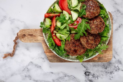 Fried cutlets, mixed minced meat, with vegetable salad, homemade, top view, no people