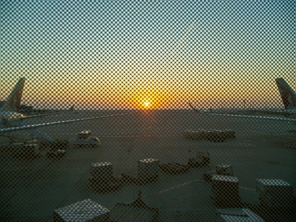 Berlin BER Airport, view through perforated window panes, taxiway at sunrise in November, Berlin,