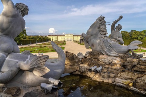 View through the Neptune Fountain to Schönbrunn Park and Palace, UNESCO World Heritage Site in