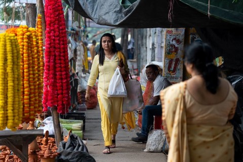 People buy Diya oil lamps and other decorative items at a market on the eve of Diwali, the Hindu