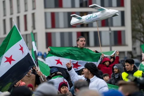 People celebrate the end of the Assad regime after the change of power in Syria at a rally on the