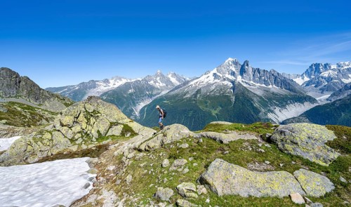 Mountaineer on a hiking trail in front of a mountain landscape, view of mountain peak Aiguille