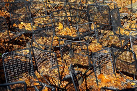 Metal wire frame chairs standing in autumn leaves, Baden-Württemberg, Germany, Europe