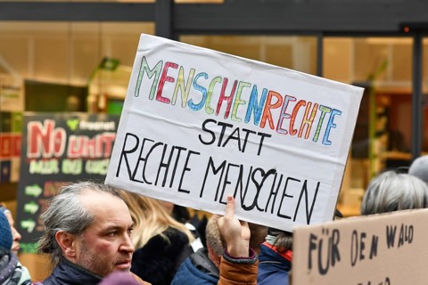 Heidelberg, Germany - February 12th 2025: Person holding up sign with text 'Human rights instead of
