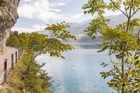 Path with a view along the steep rock faces on the northern shore of Lake Walen, Amden, St. Gallen,