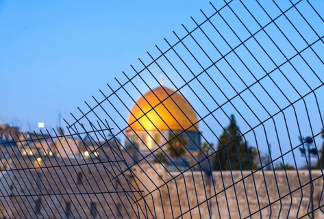 Islamic shrine Dome of Rock in the Old City seen through the fence. Symbol of Palestinian