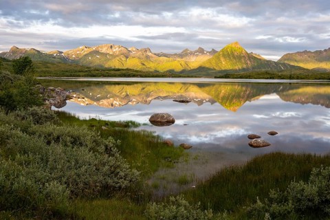 Mountains reflected in the sea, near Laukvik, Austvågøya, Lofoten, Norway, Europe