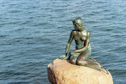The famous bronze figure of The Little Mermaid - Den lille Havfrue - on the Langelinie waterfront