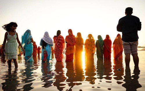 Hindu devotees perform rituals as they offer prayers to the Sun god in the bank of Brahmaputra