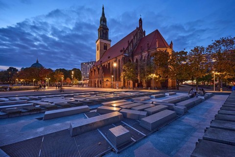 Water cascades and St. Mary's Church with trees at dusk, Karl-Liebknecht-Straße, Berlin, capital