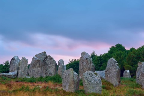 Neolithic menhirs, standing stones in Carnac with dramatic stormy sky, Carnac, Quiberon, Morbihan,