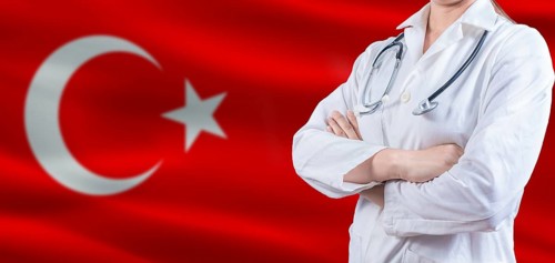 Doctor with crossed arms on Turkey flag. Turkey Health and Care concept. Female doctor on Turkey