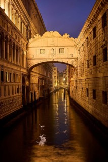 View from 'Ponte della paglia' on the bridge 'Bridge of Sighs' over a waterway at the blue hour in