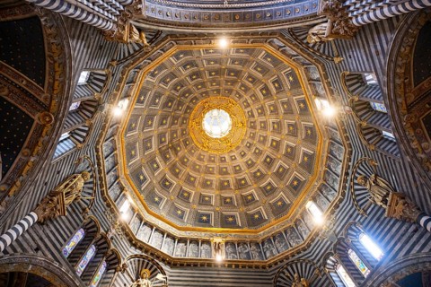 The dome of the cathedral with starry sky and black and white striped marble columns and round