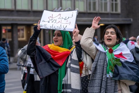Syrian woman celebrate the end of the Assad regime after the change of power in Syria at a rally on