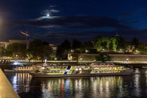 City view with Elbe in the evening, steamer departure, illuminated silhouette at the blue hour,