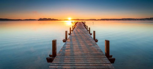 Jetty at Wörthsee at sunrise, fog on the water, Bavaria, Germany, Europe