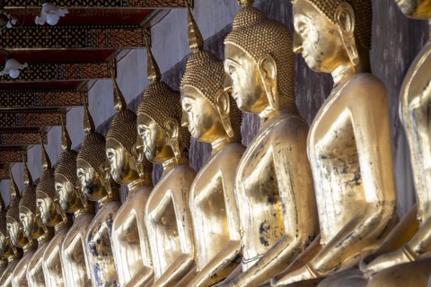 Buddha statues in meditation posture in Phra Rabiang Kot around the Phra Wihan Luang, Wat Suthat