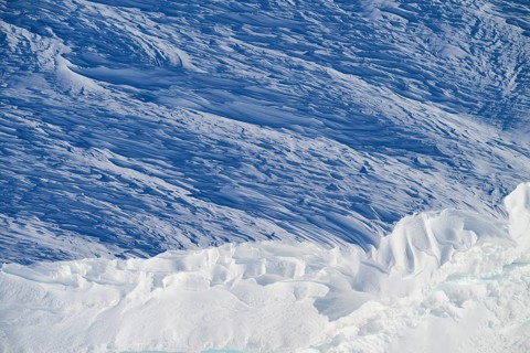 Snow-covered landscape with layers of ice and blue tones, impressive texture and natural cold, snow