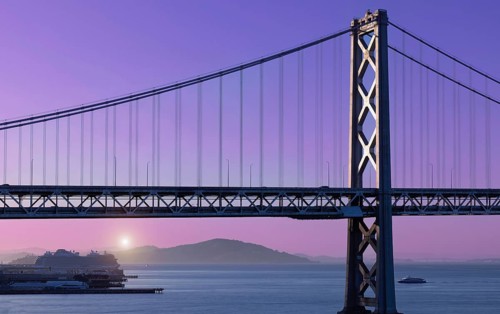 Cruise ship docked near panoramic San Francisco financial skyline near Oakland Bay Bridge