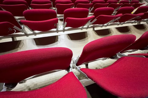 Empty folded-up seats Folding chairs with backrests in rows of seats mounted next to each other