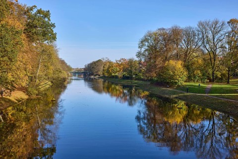 Canal Trave with autumnal trees, blue sky, Hanseatic city of Lübeck, Schleswig-Holstein, Germany,