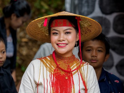 Toraja woman in traditional colourful clothes with rice straw hat, smiling, portrait, Tana Toraja,