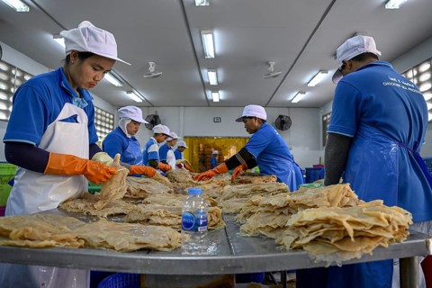 Employees of the company Chockdee Sea Products prepare dried jellyfish for export, Min Buri, near