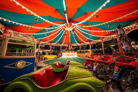 Lively carousel with colourful lights and children's vehicles, Christmas market Ludwigsburg,