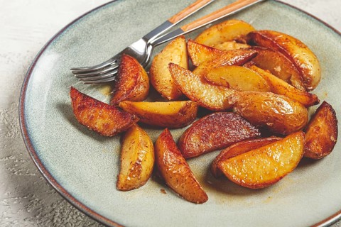 Fried potato slices, on a plate, top view, homemade, no people