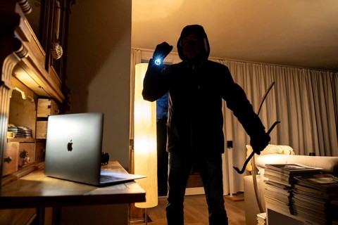 Symbolic image of a burglary, perpetrator has broken into a flat from the garden side and is